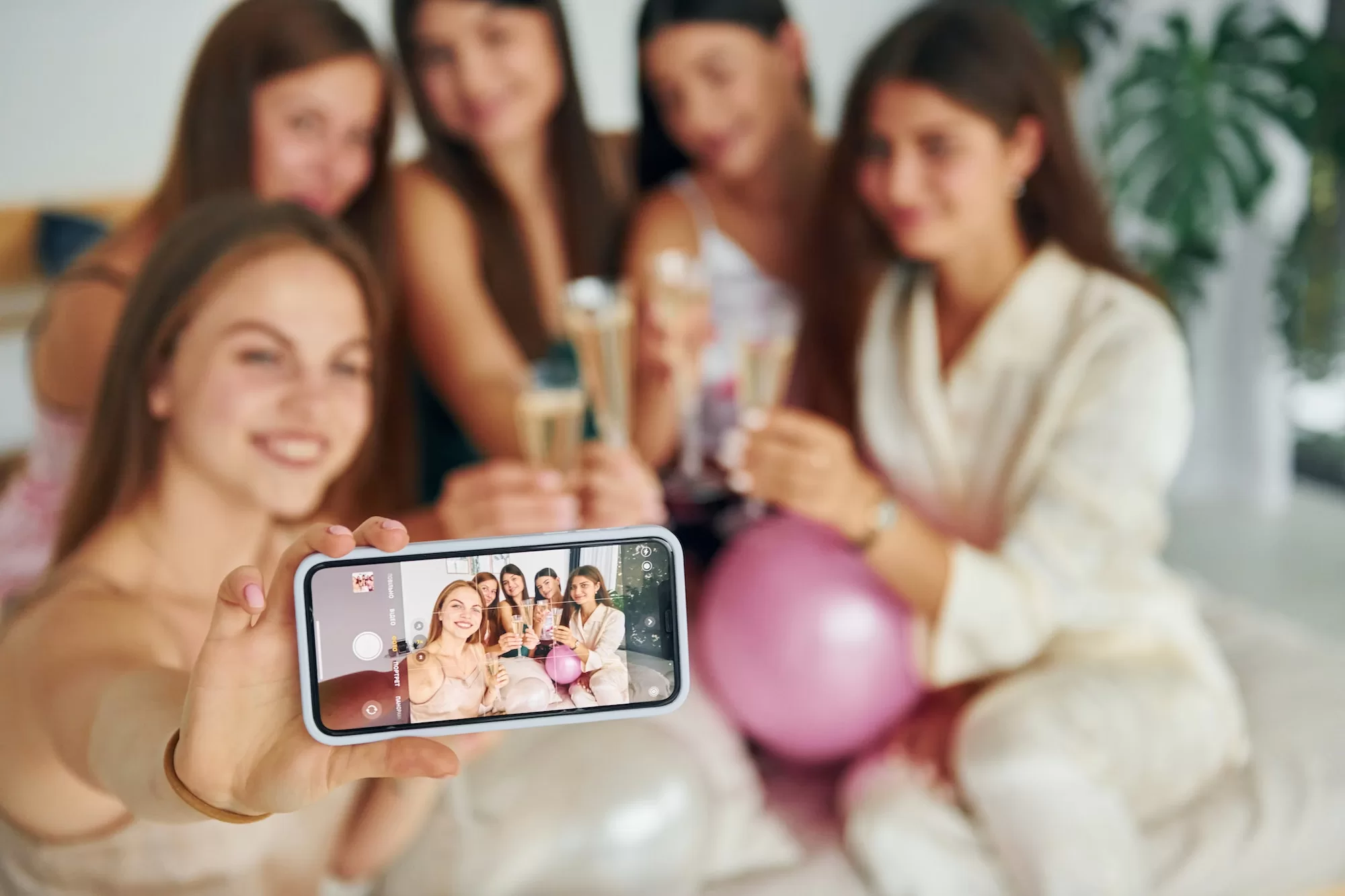 Holding glasses with drink. Group of happy women that is at a bachelorette party